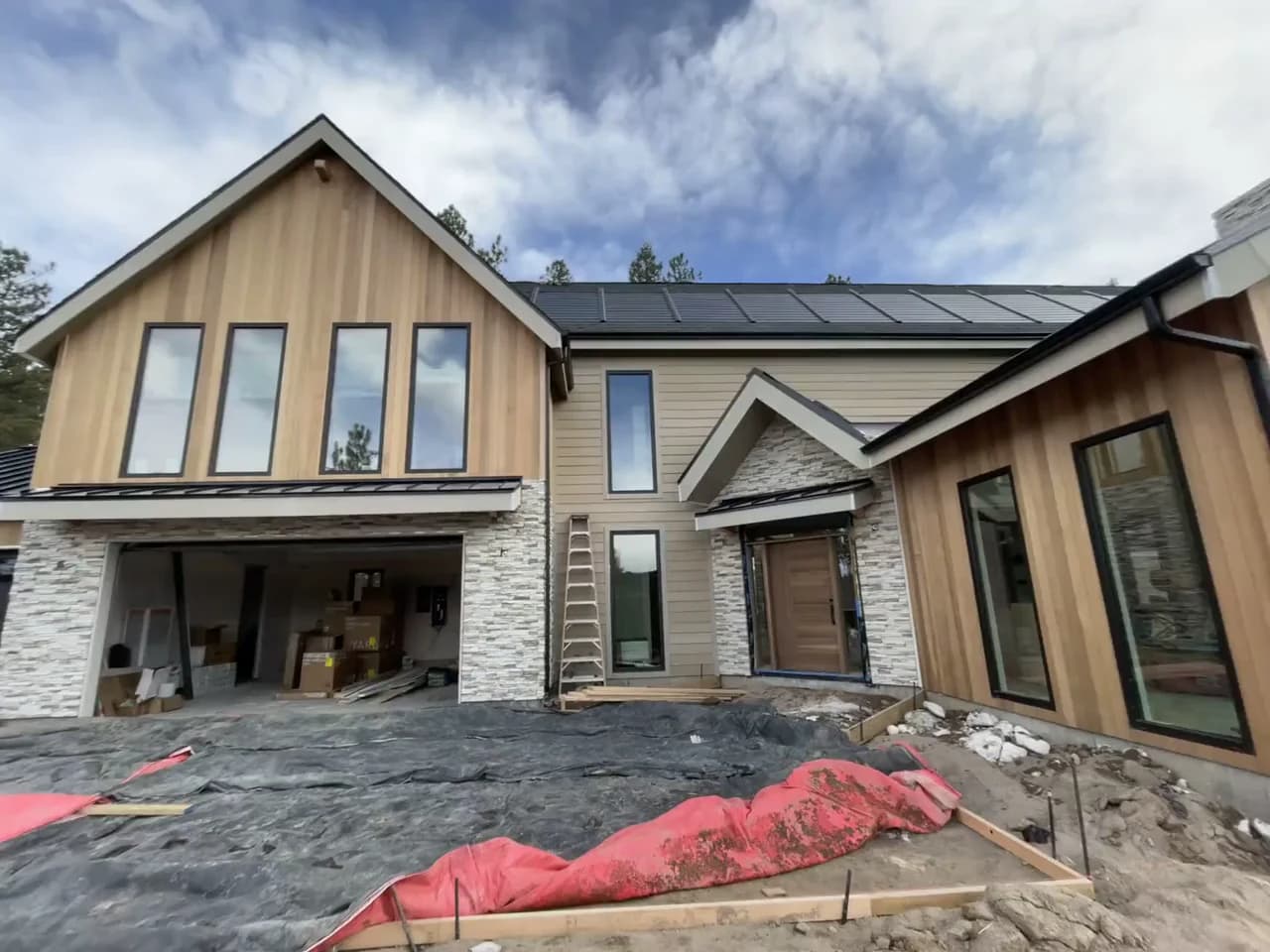Residential metal and shingle roof planes with adjoining exterior materials