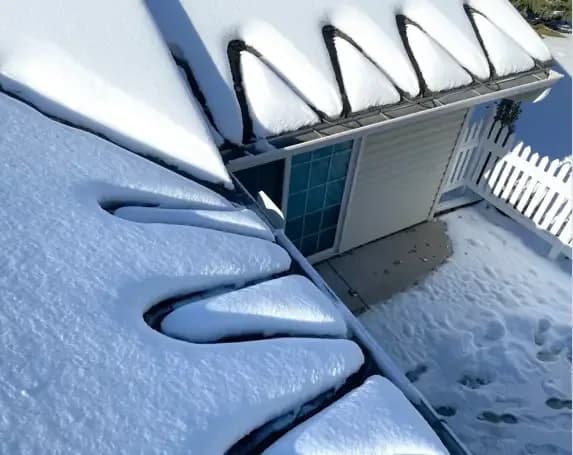 Self-regulating roof heat cable routed at eaves and valleys to prevent ice dams on Colorado homes