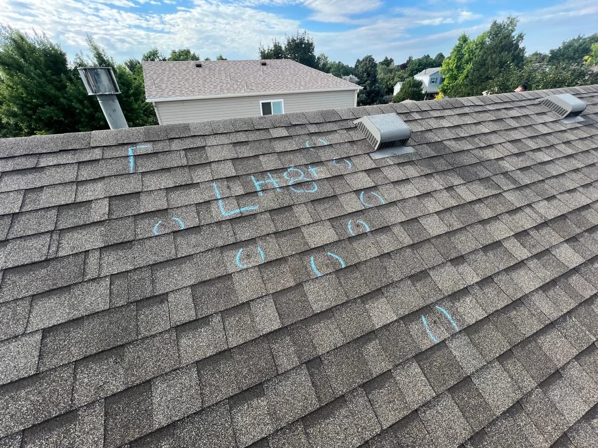 Shingle roof surface with blue chalk inspection marks